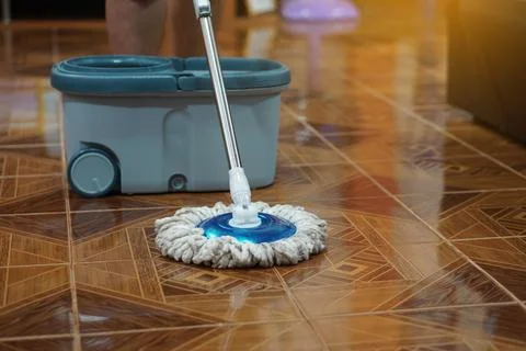 Close up of man using a mop to mop the floor. Stock Photos