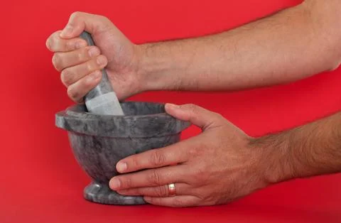 Close up of a man using a mortar and pestle Stock Photos