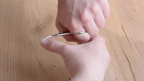 Close up of a man using a nail scissors to cut his nails. Personal care concept Stock Footage 196826593