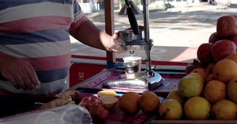 Close up of Man Using Old Fashion Juicer to Make Orange Juice Video stock 68686799