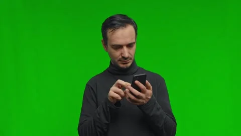 Close up of man using phone surfing, texting message, scrolling , on the green Stock Footage 246292982