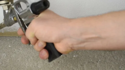 Close-up of a man using a polyurethane foam material from a pistol under pres Video stock 118373018