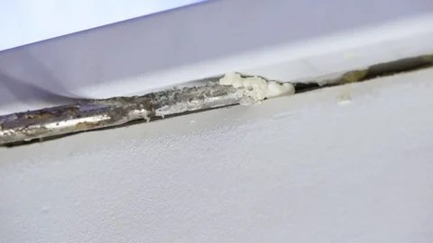 Close-up of a man using a polyurethane foam material from a pistol under pres Stock Footage 118373046