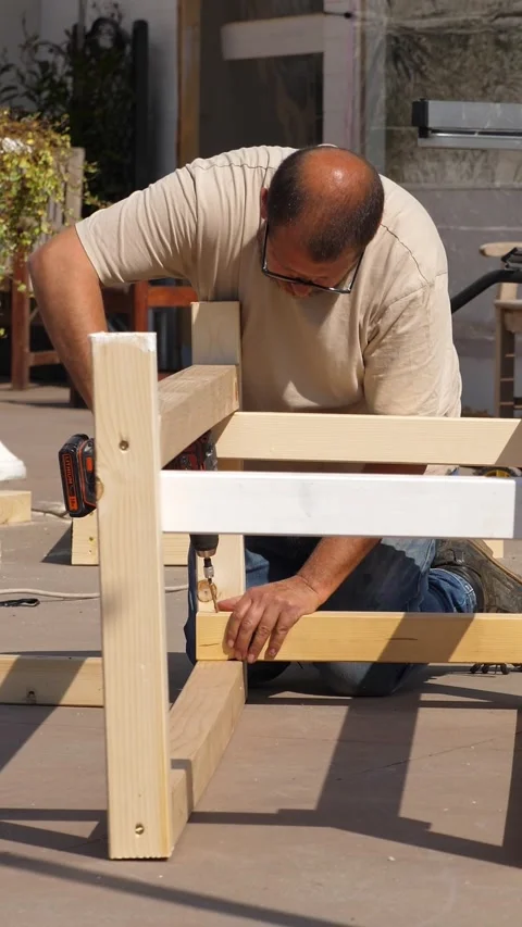 Close-up of man using power drill to build planter Video stock 309835084