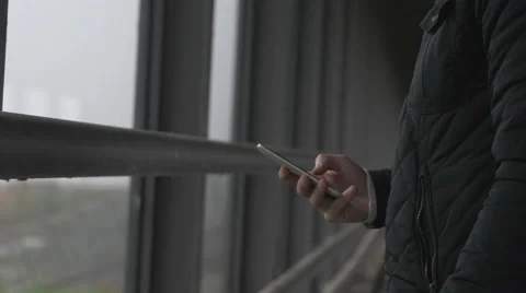 Close-up of a man using smart phone at a footbrigde Stock Footage 68679303