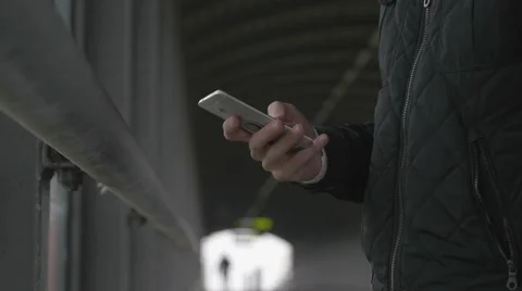 Close-up of a man using smart phone at a footbrigde Stock Footage 68679325