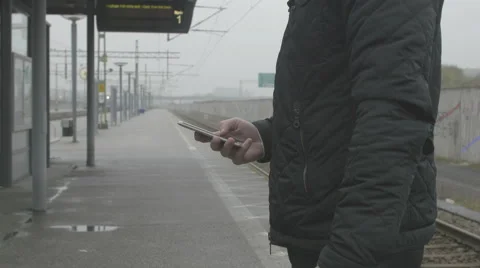 Close-up of a man using smart phone at train station Stock Footage 68713681