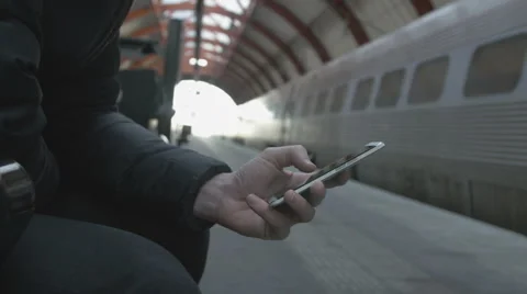 Close-up of a man using smart phone at train station Stock Footage 68759950