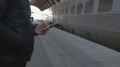 Close-up of a man using smart phone at train station Stock Footage 68759980