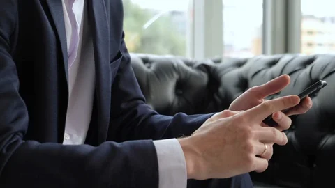 Close up Man using smart phone. Man working in modern office late at night Stock Footage 129637274