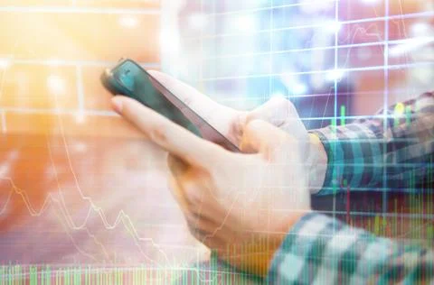 Close up of man using smart phone trading stock exchange market in coffee cafe Stock Photos