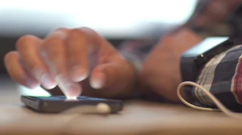 Close-up of a man using a smart watch and phone in cafe Stock Footage 68043124