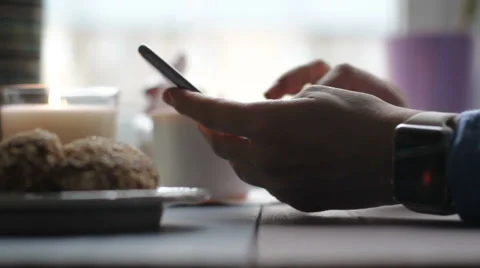 Close-up of a man using a smart watch and phone in cafe Stock-Footage 68908655