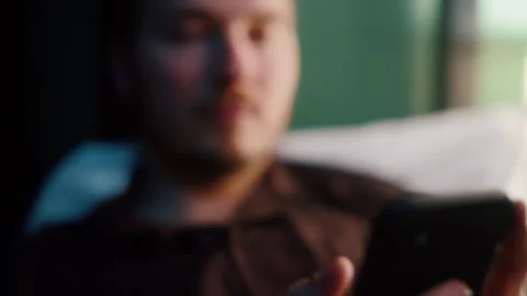 Close-up of man using smartphone in bed at night 스톡 동영상 319544021