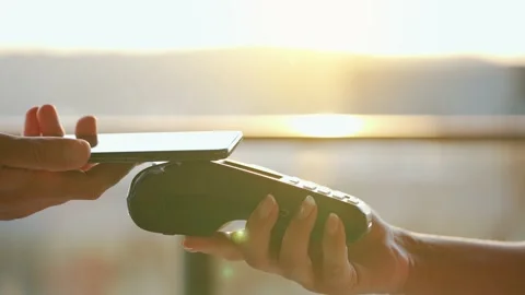 Close-up, man using smartphone cashless wallet NFC technology to pay order on Stock Footage 163164341