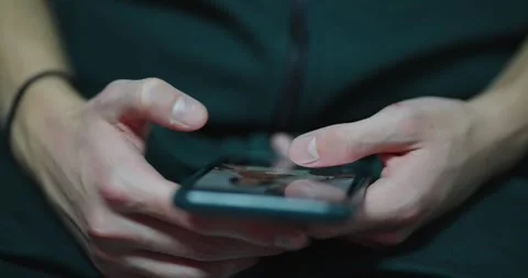 Close-up of a man using smartphone in a dark setting Stock Footage 288412426