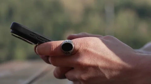 Close-Up of a Man Using a Smartphone 動画素材 338186106