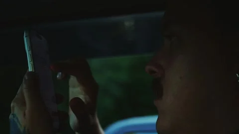 Close-up of a man using a smartphone inside a car cabin. Mobile shopping... Vídeos de archivo 341613039