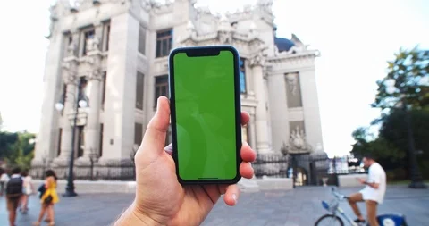 Close-up man using smartphone with mock-up green screen chromakey against Stock Footage 115672505