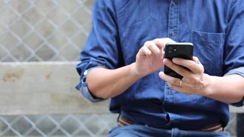 Close up of a man using a smartphone, outdoor, daytime Video stock 150342055