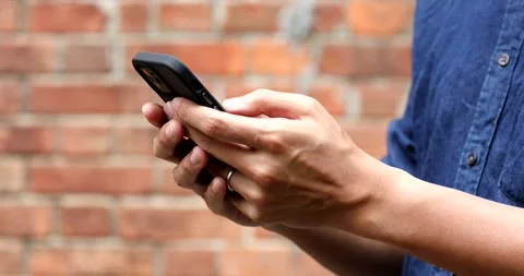 Close up of a man using a smartphone, outdoor, daytime Video stock 150342079