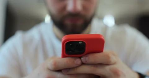 Close-up man using smartphone while sitting on couch using app on cellphone at Stock Footage 269129114
