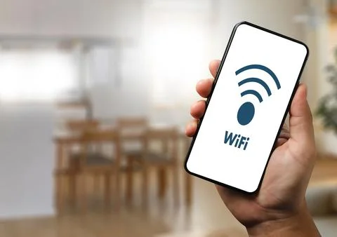 Close-up man using smartphone with wifi icon communication social network b.. Stock Photos