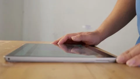 Close up of a man using tablet, browsing internet with gadget Stock Footage 231682191