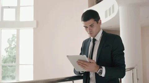 Close up of man using a tablet for his work. He is looking at the technology Stock Footage