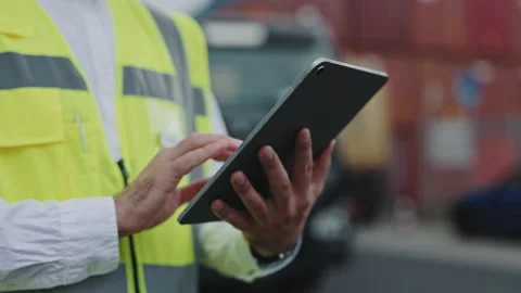 Close up of man using tablet at warehouse harbor Stock Footage 166560947