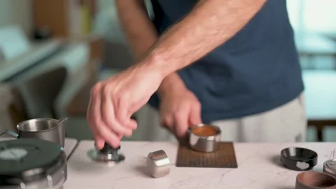 Close-Up Of A Man Using Tamper to Press Coffee Grounds In A Portafilter Video stock 329614872