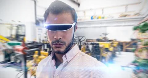 Close up of man using a virtual reality device against mechanic workshop Stock Photos
