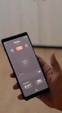 Close up of man using voice activated application to turn on bulbs 写真素材