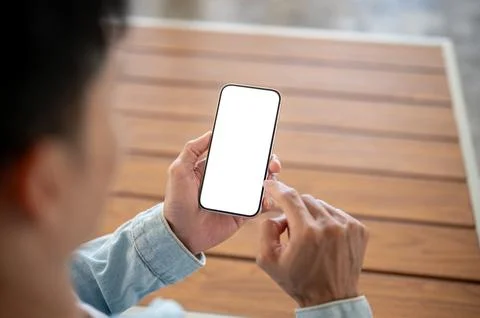Close up of a man using white screen smartphone over wooden table, suitable.. Stockfoto's
