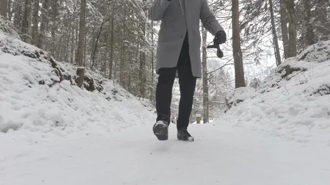 Close up man walk in the winter time on the snowy road camera footage Stock Footage 86087398