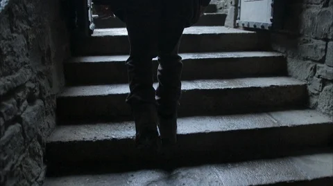 Close up on man walking up Dark stone stairway towards daylight Stock Footage 128668954