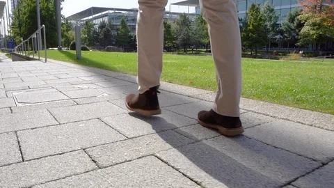 Close up of man walking through business park, slow motion Stock Footage 96065010