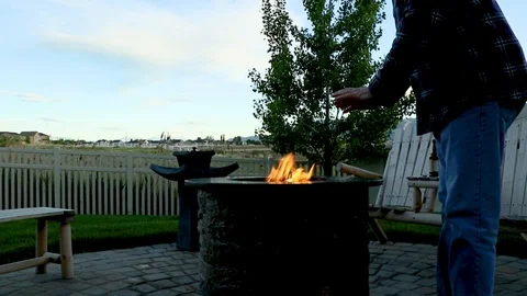Close up of man warming his hands at a backyard firepit Stock Footage 89768652