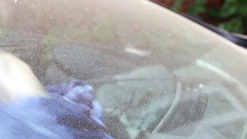 Close-up man washes the glass of the car from the inside with a napkin Stock Footage 202096238