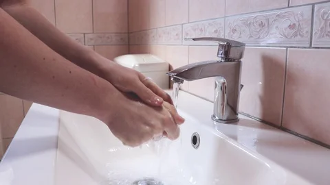 Close-up of man washing hands with soap under bathroom sink to prevent disease Stock-Footage 129618756
