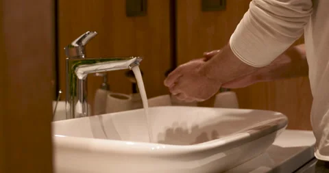 Close up of man washing hands with soap in white sink Stock Footage 134520947