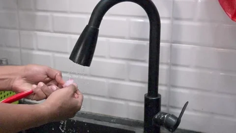 Close up a man washing toothbrush after using Stock Footage 345774158