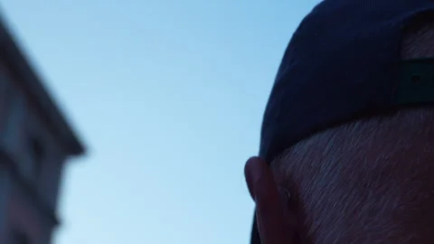 Close Up Of Man Wearing Baseball Cap Looking At Madrid Cityscape Stock Footage 343025206
