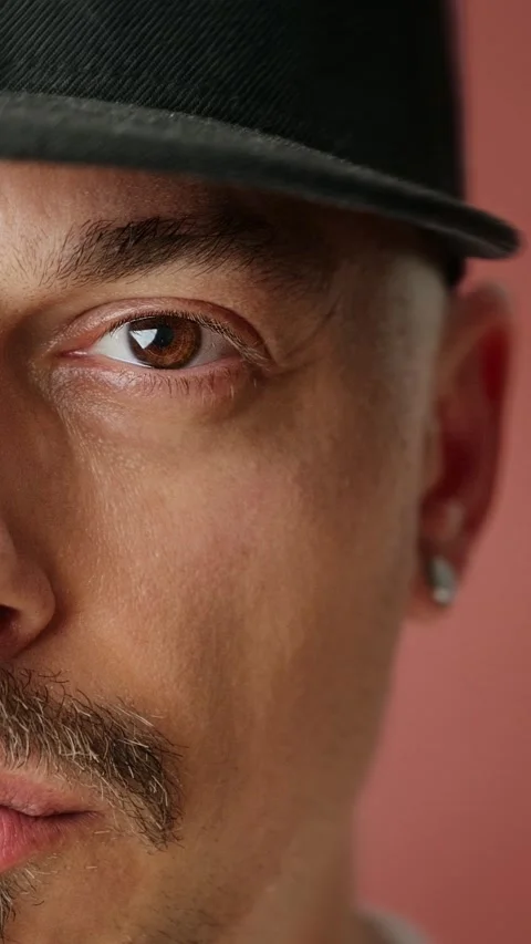 Close-up of a man wearing a black cap with a goatee. 動画素材 292496695