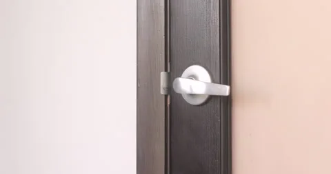 Close up of man wearing gloves opening and closing door 動画素材 130673030