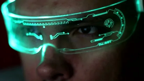 A close-up of a man wearing glowing technology glasses working on a computer Stockbeeldmateriaal 333706999