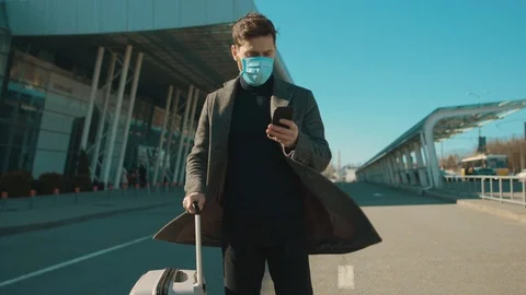 Close up man wearing Protective Face Mask use phone coughs hold suitcase COVID Stock Footage 126575074