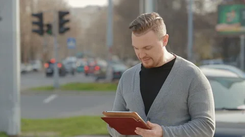 Close-up of the man who corresponds with someone in the tablet Stock Footage 62171493