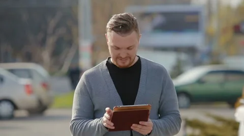 Close-up of the man who thumbs through news on the tablet Video stock 62171491