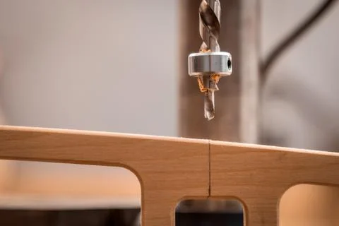 Close up of a man with work clothes and a carpenter's hat is carving a wooden Stock Photos